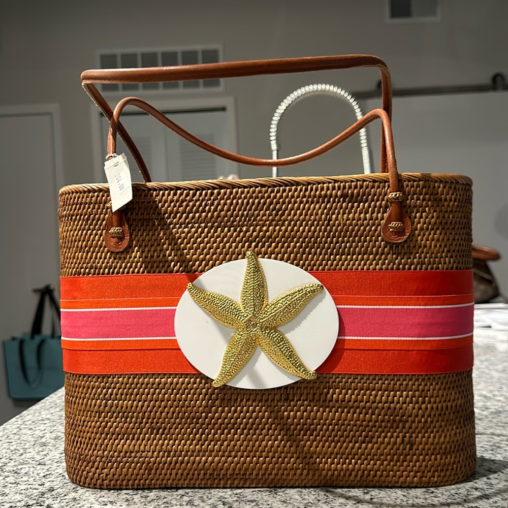 Never used. New with tag. Darling woven structured beach purse. Iconic colors.